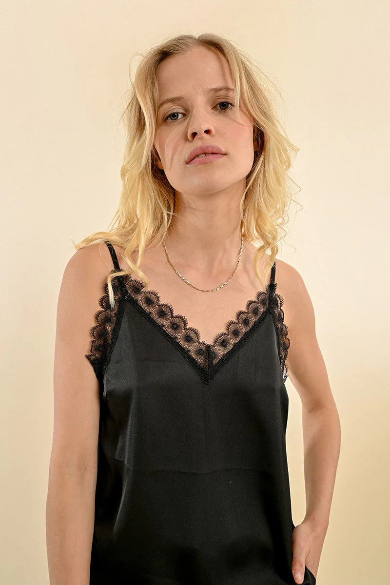 A person with long blonde hair wearing the Molly Bracken Satin Cami with Lace Detail.