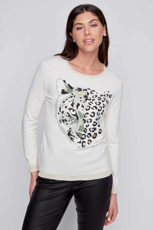 A person stands against a gray background, donning a stylish and cozy look with a CoCo Y Club Round Neck Leopard Sweater and black pants.