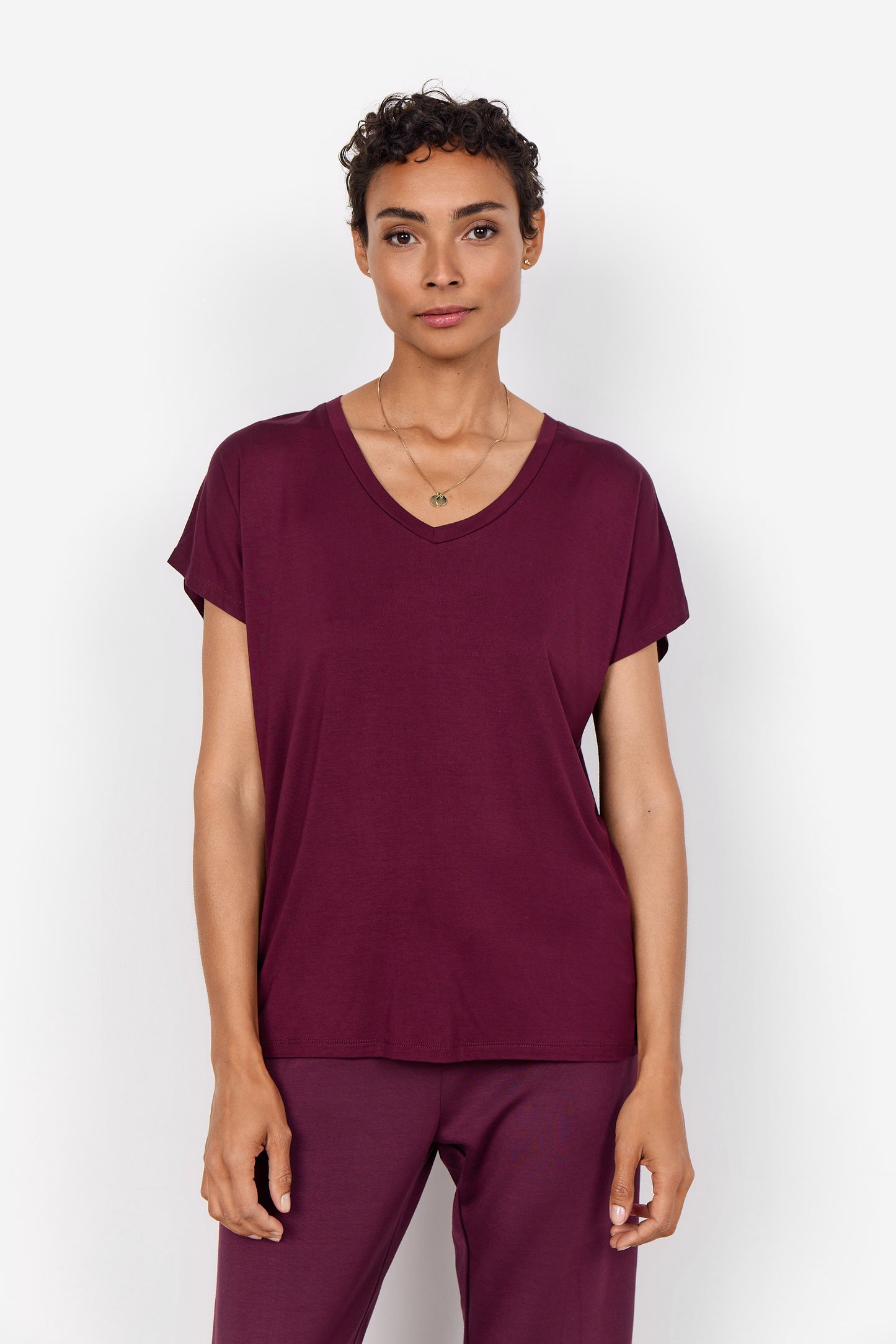 The Basic Marica Tee by Soya Concepts is a burgundy short-sleeve V-neck T-shirt made from a soft lyocell blend, set against a white background—a true wardrobe essential.