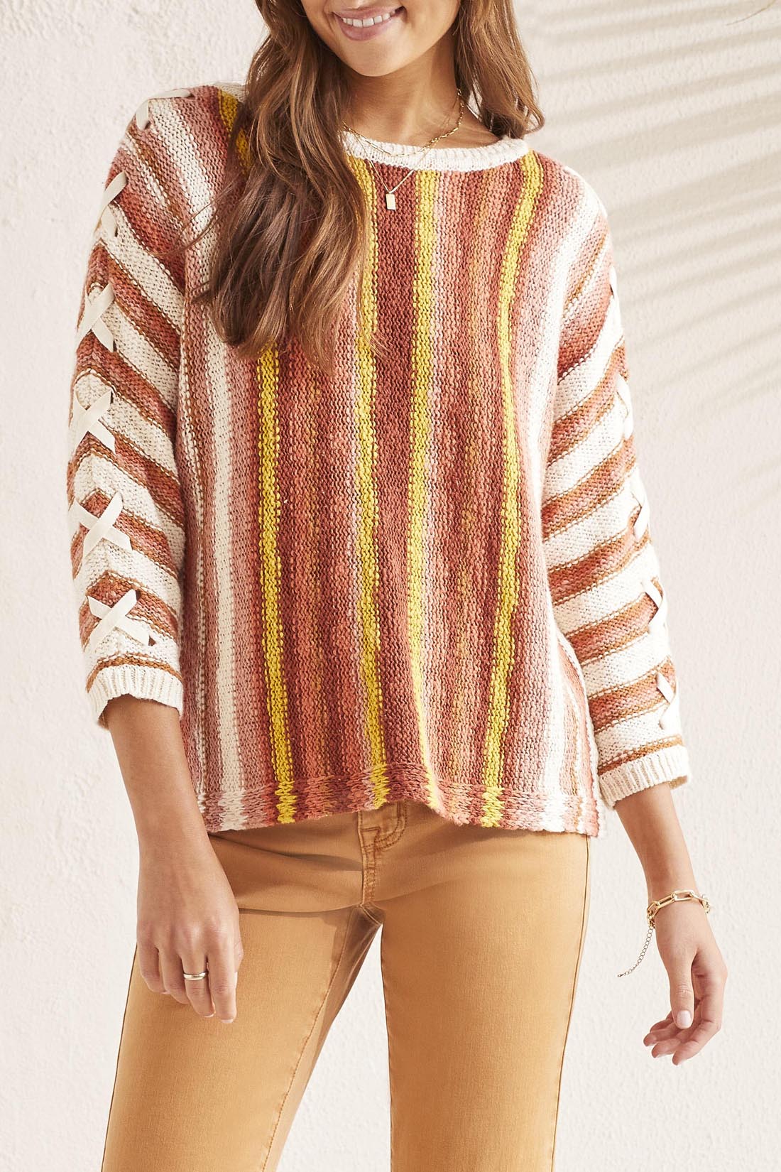 A woman wearing a Tribal 3/4 Sleeve Lace Up Boat Neck Sweater.