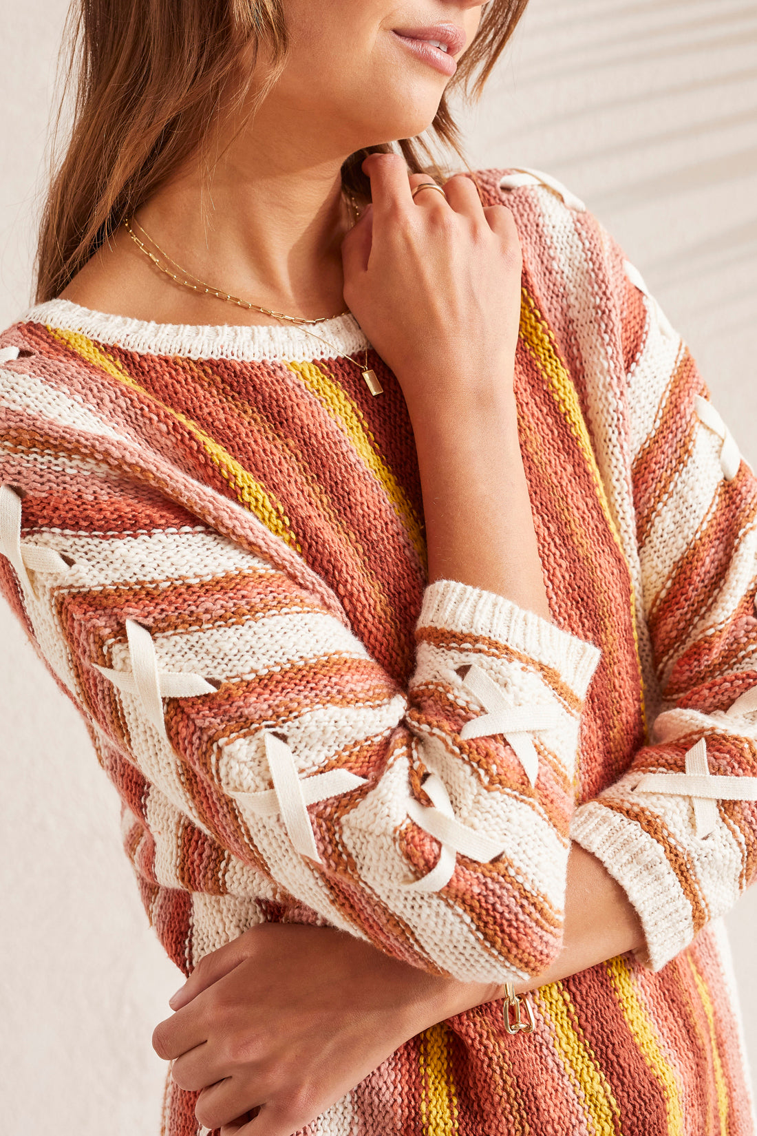 A woman wearing a Tribal 3/4 Sleeve Lace Up Boat Neck Sweater.