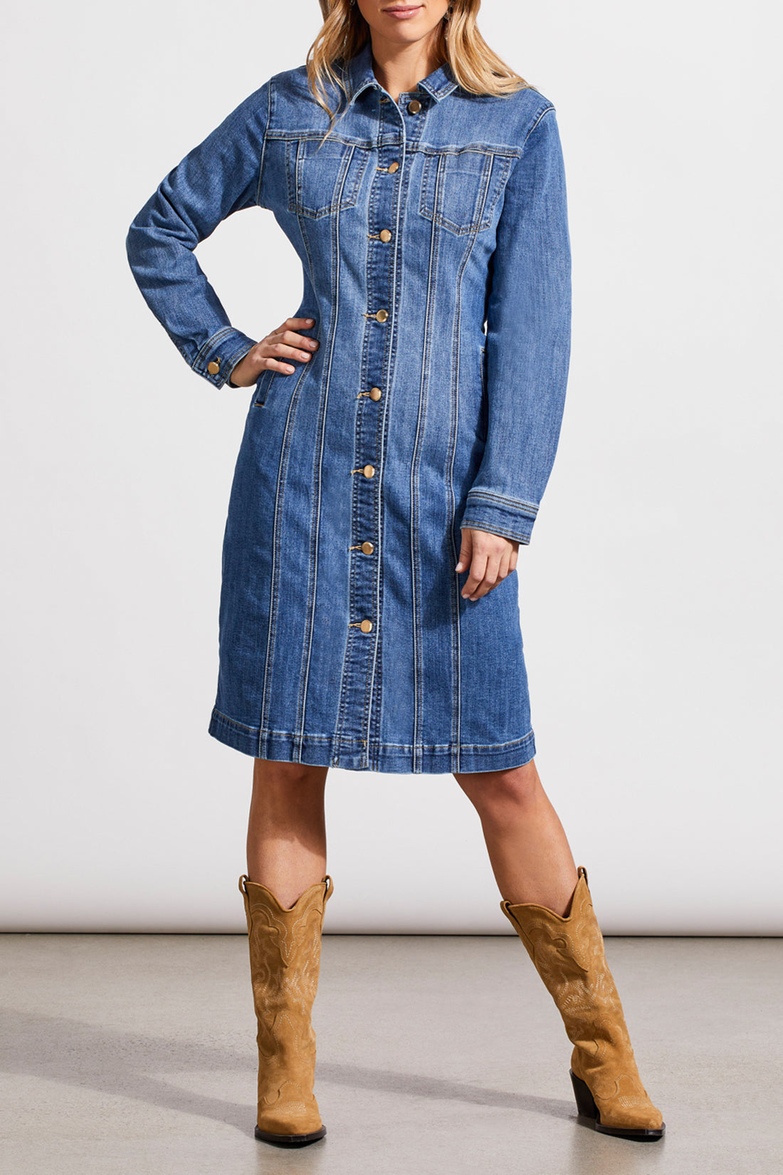 A woman wearing a trendy Tribal Long Fitted Denim Dress Jacket and cowboy boots.