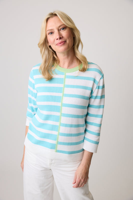 A person wearing the Parkhurst Adeline Stripe Sweater and white pants stands against a plain backdrop.