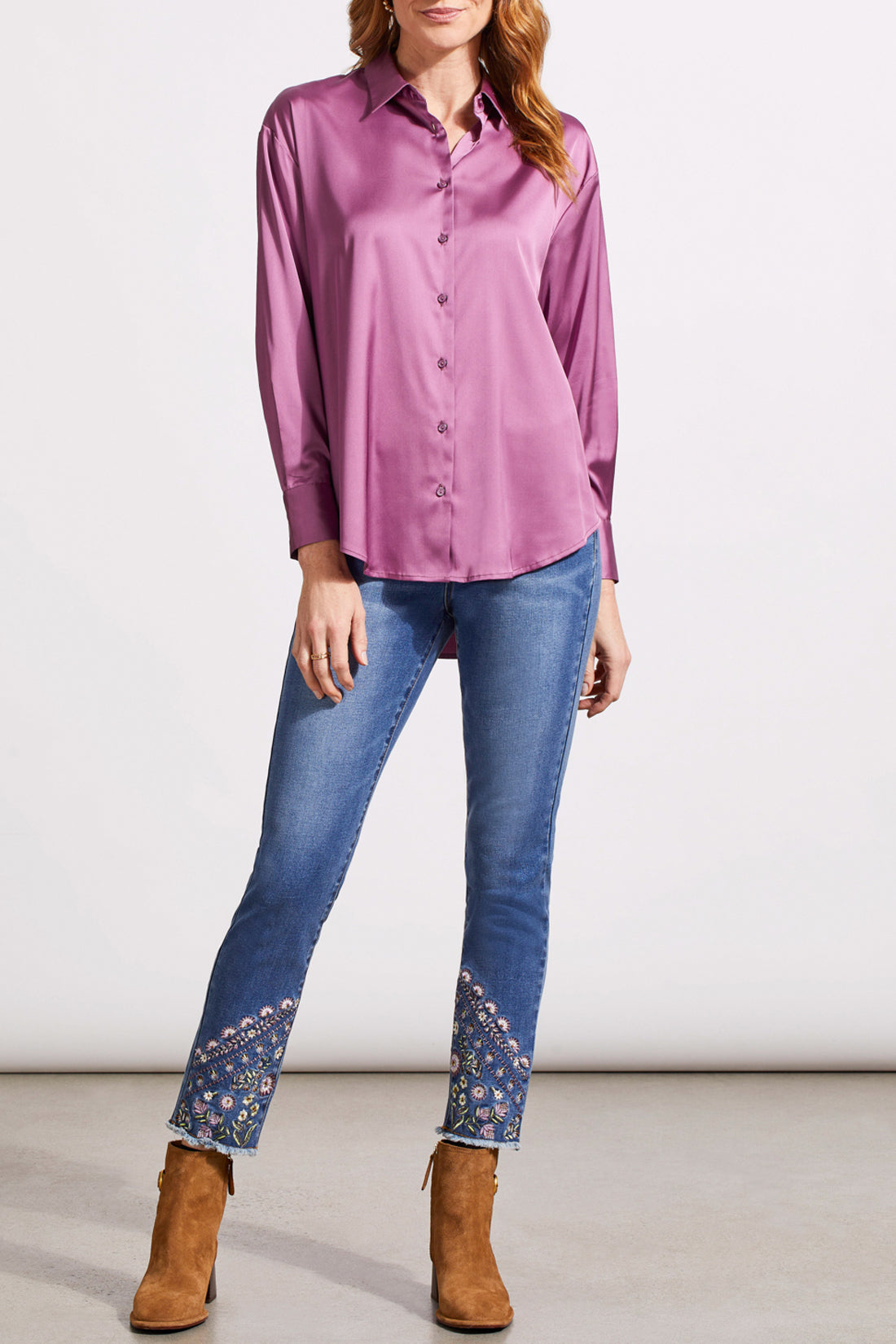 A person dressed in a cozy fall top, specifically the beige Drop Shoulder Shirt by Tribal with silk fabric, pairs it effortlessly with dark jeans against a light background.