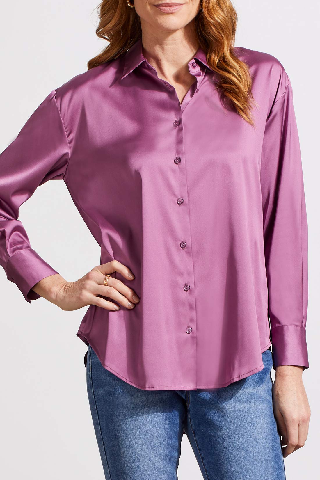 A person dressed in a cozy fall top, specifically the beige Drop Shoulder Shirt by Tribal with silk fabric, pairs it effortlessly with dark jeans against a light background.