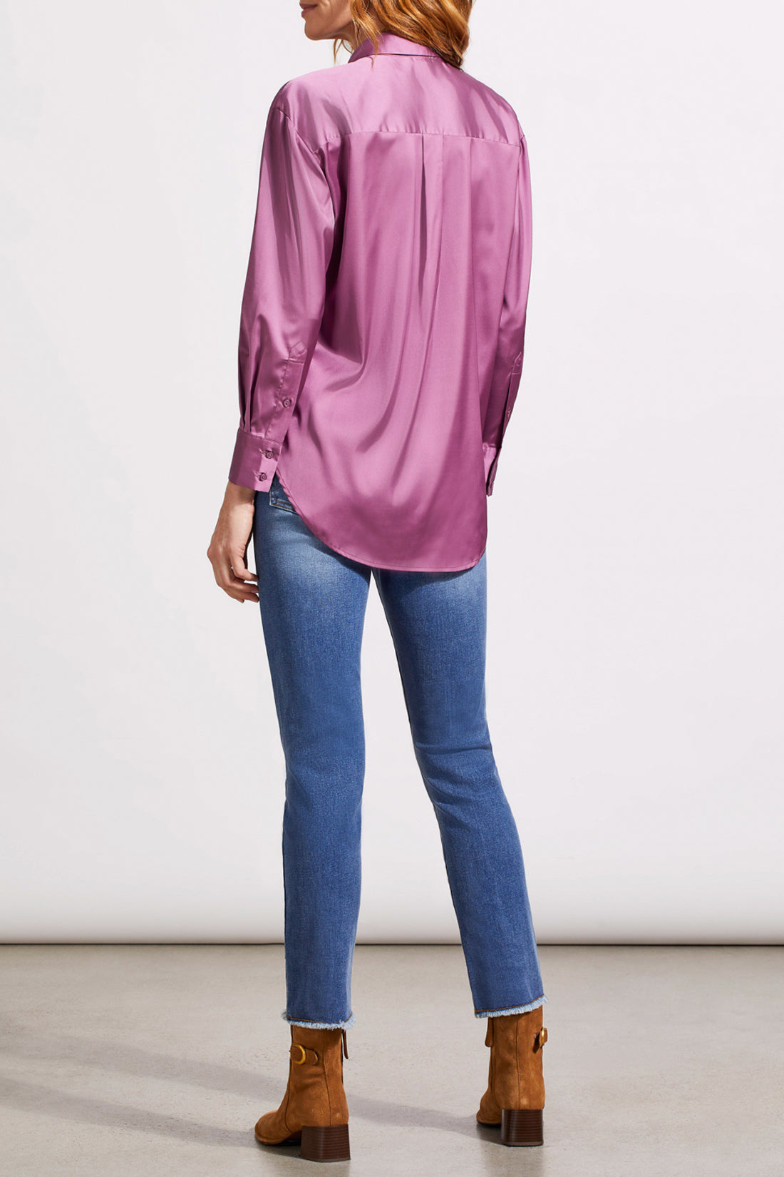 A person dressed in a cozy fall top, specifically the beige Drop Shoulder Shirt by Tribal with silk fabric, pairs it effortlessly with dark jeans against a light background.