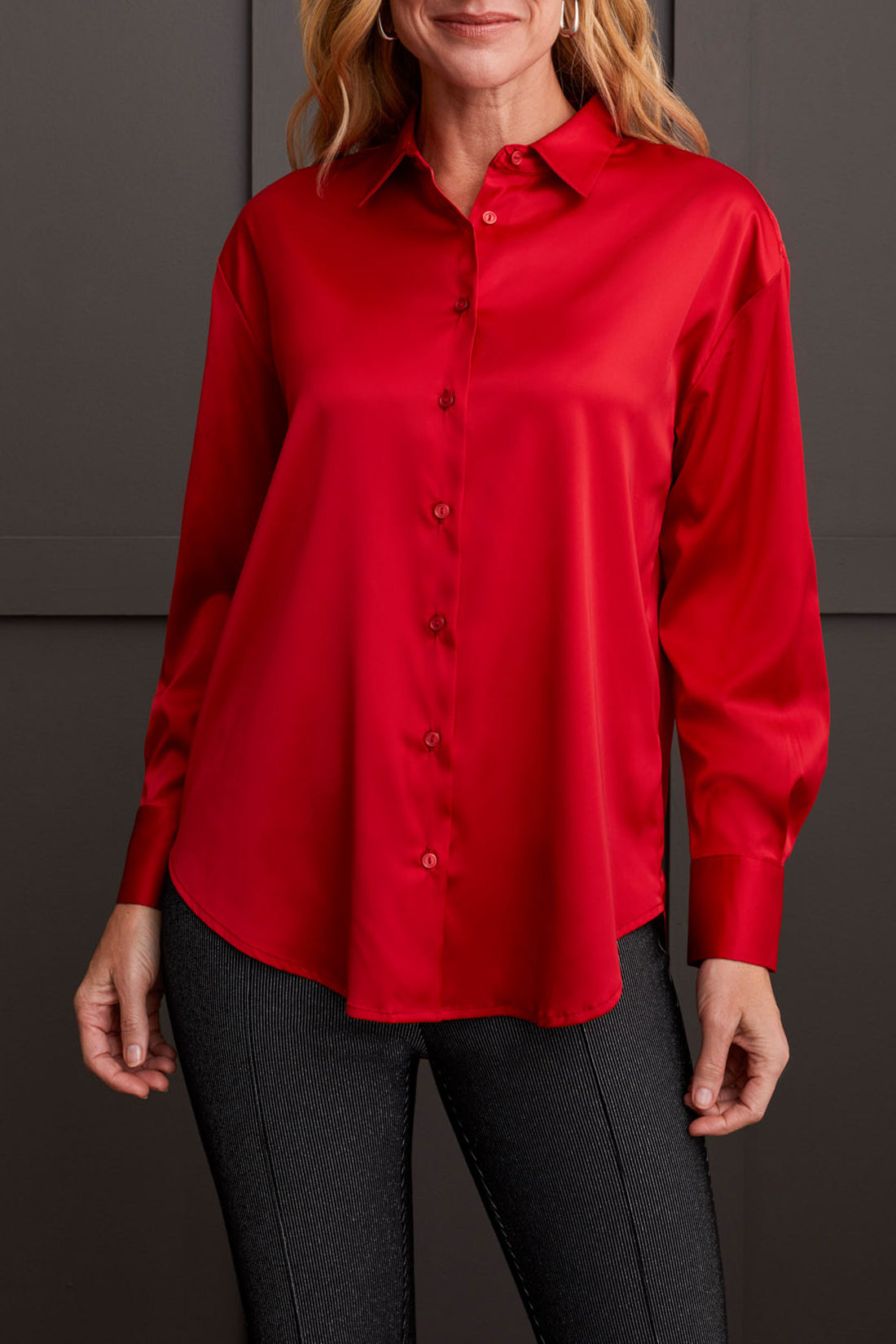 A person dressed in a cozy fall top, specifically the beige Drop Shoulder Shirt by Tribal with silk fabric, pairs it effortlessly with dark jeans against a light background.