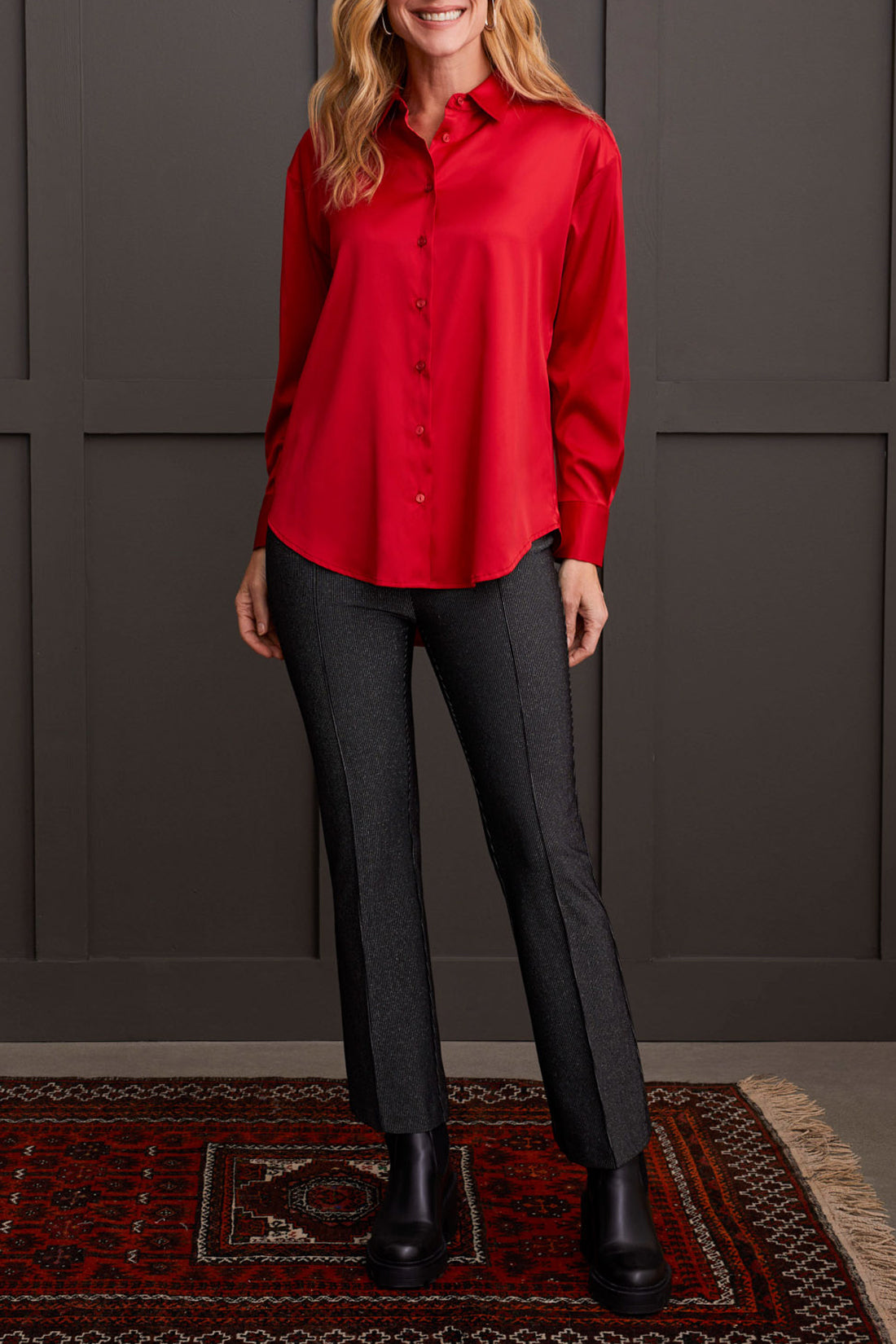 A person dressed in a cozy fall top, specifically the beige Drop Shoulder Shirt by Tribal with silk fabric, pairs it effortlessly with dark jeans against a light background.