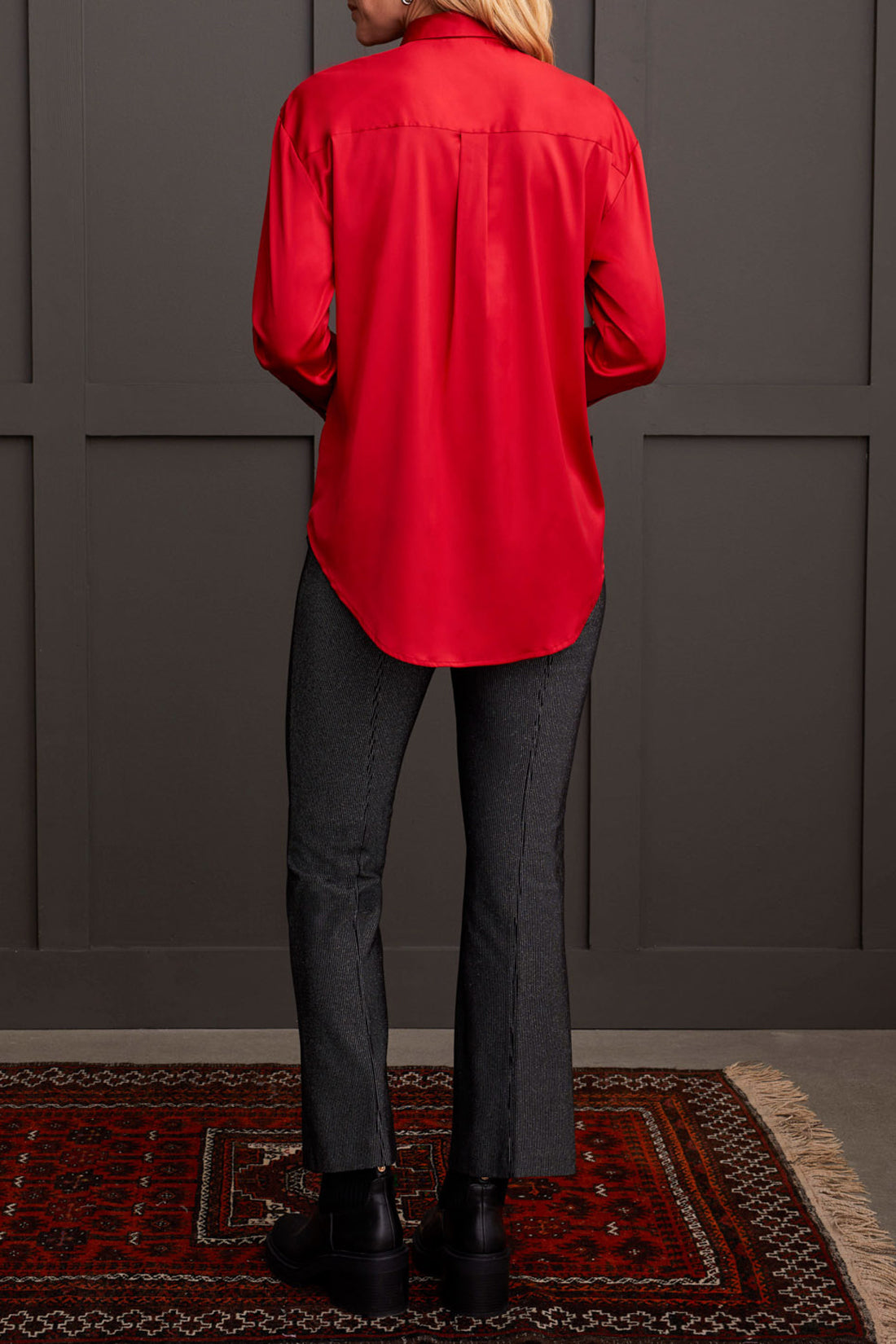 A person dressed in a cozy fall top, specifically the beige Drop Shoulder Shirt by Tribal with silk fabric, pairs it effortlessly with dark jeans against a light background.