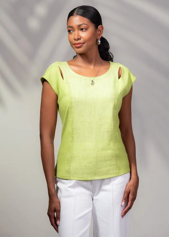 Someone in Alison Sheri's light green Cap Sleeve Linen Rib Top and breezy white pants poses against a blurred background.