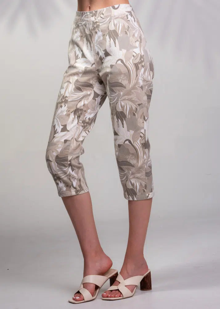 Someone models a stylish summer outfit featuring the Floral Pull On Capris Pant by Alison Sheri in beige and white, paired with chic brown and white open-toe heels on a plain backdrop.