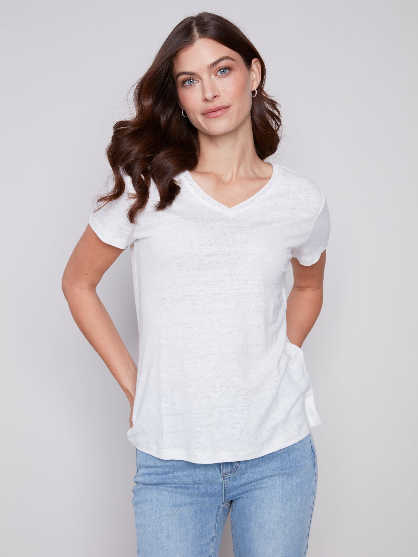 The model is wearing a pink Charlie B Linen V Neck T-Shirt, showcasing its versatility.