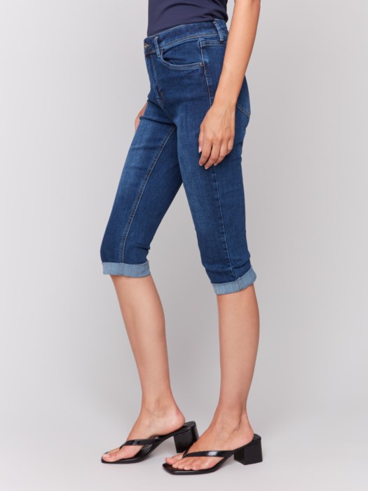 Someone wearing Charlie B's Stretch Denim Pedal Pusher Pants, rolled at the hem with a dark top and block-heeled sandals.