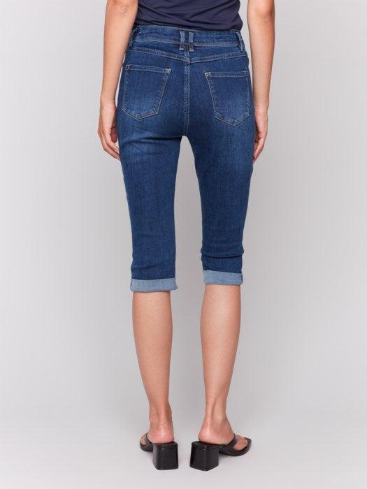 Someone wearing Charlie B's Stretch Denim Pedal Pusher Pants, rolled at the hem with a dark top and block-heeled sandals.