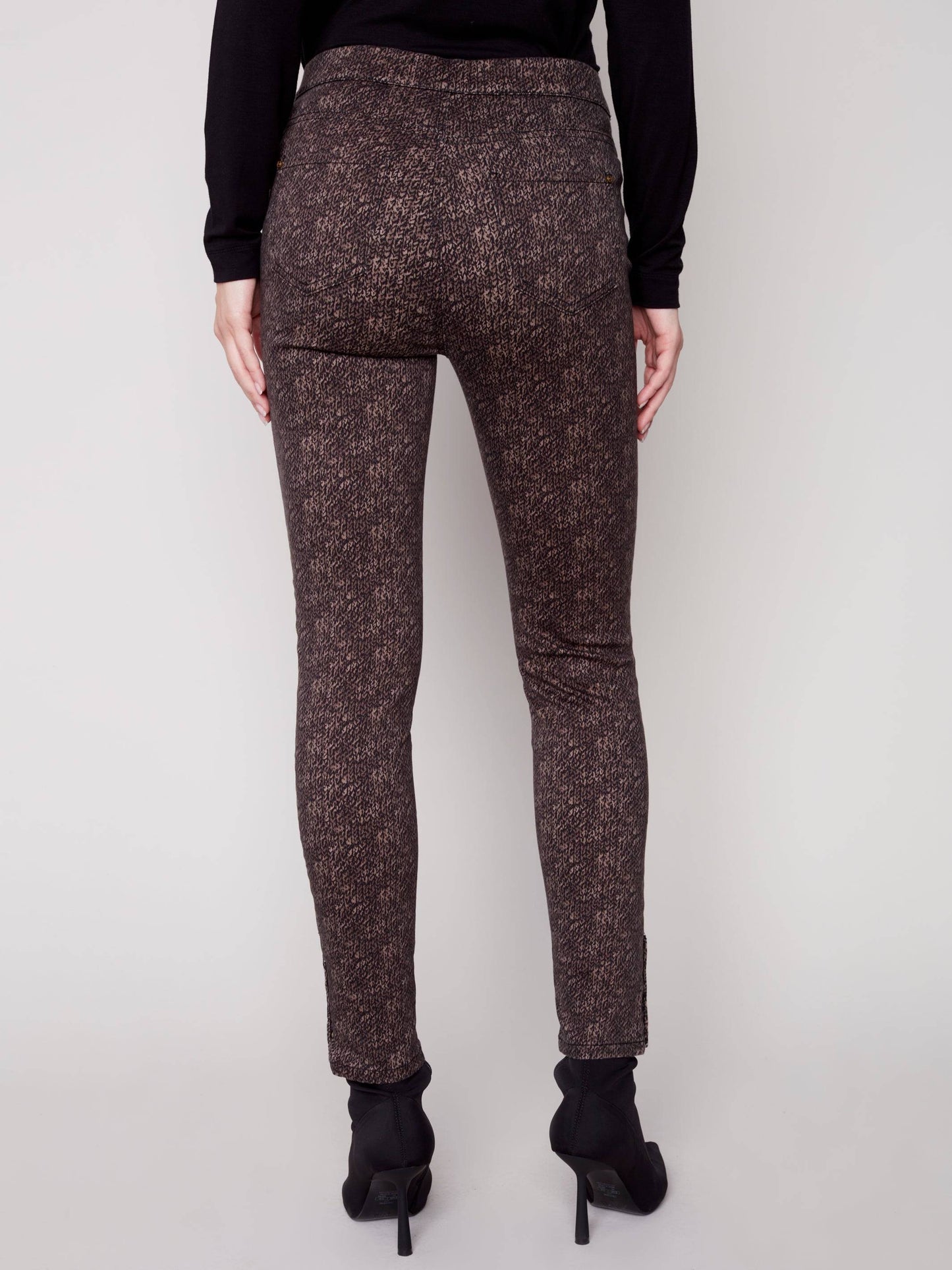 The model is wearing a black turtleneck and brown Charlie B Printed Twill Pull On Pant.