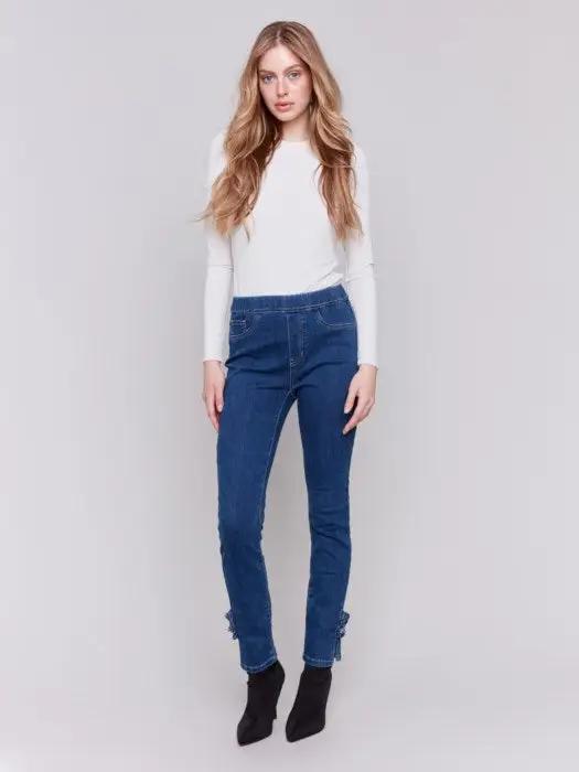 A person wearing Charlie B's Pull On Side Rose Hem Pant with a sleek silhouette and black ankle boots, standing against a plain background.