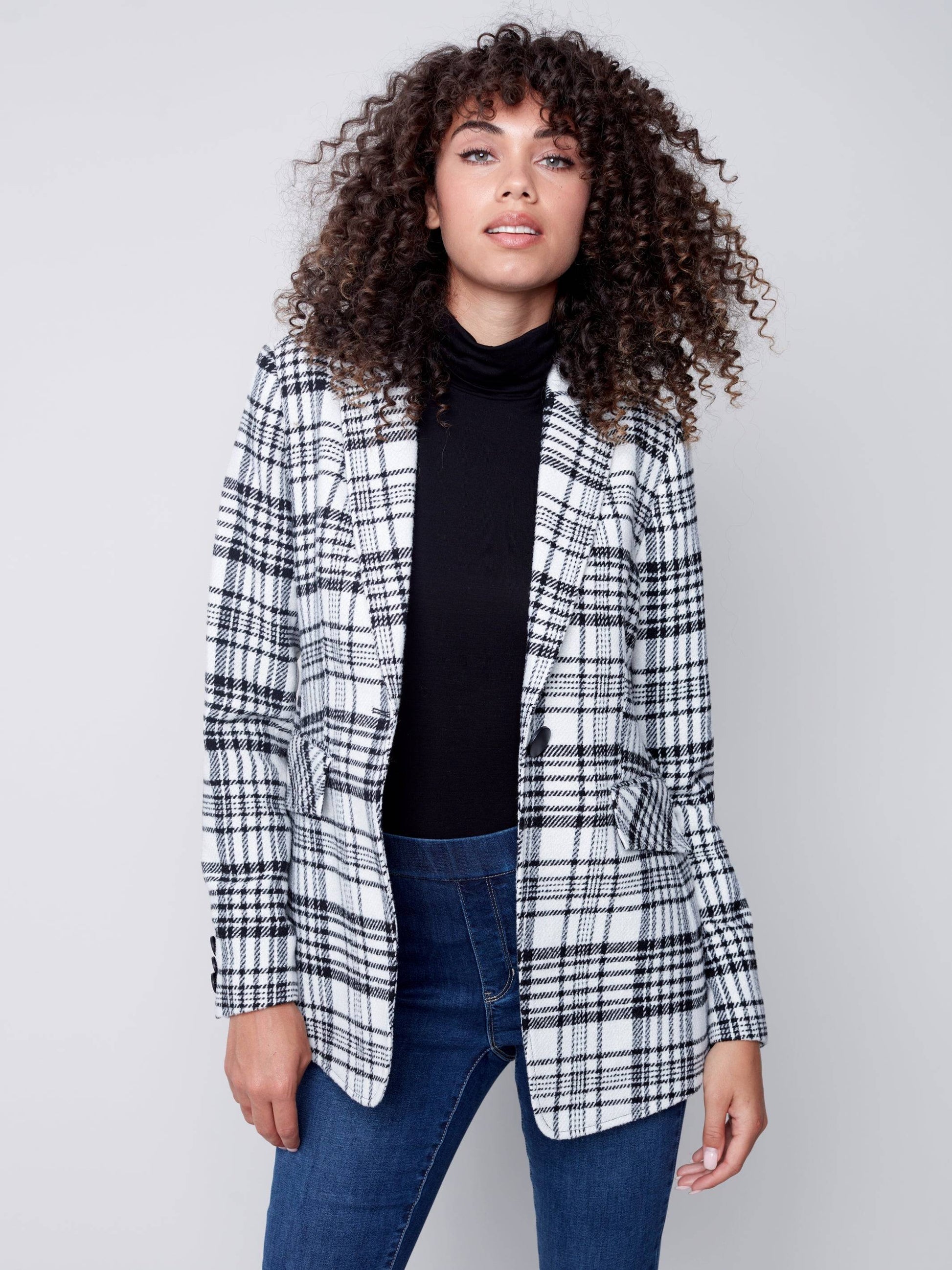 A woman wearing a Charlie B Plaid Long Blazer, perfect for formal occasions.