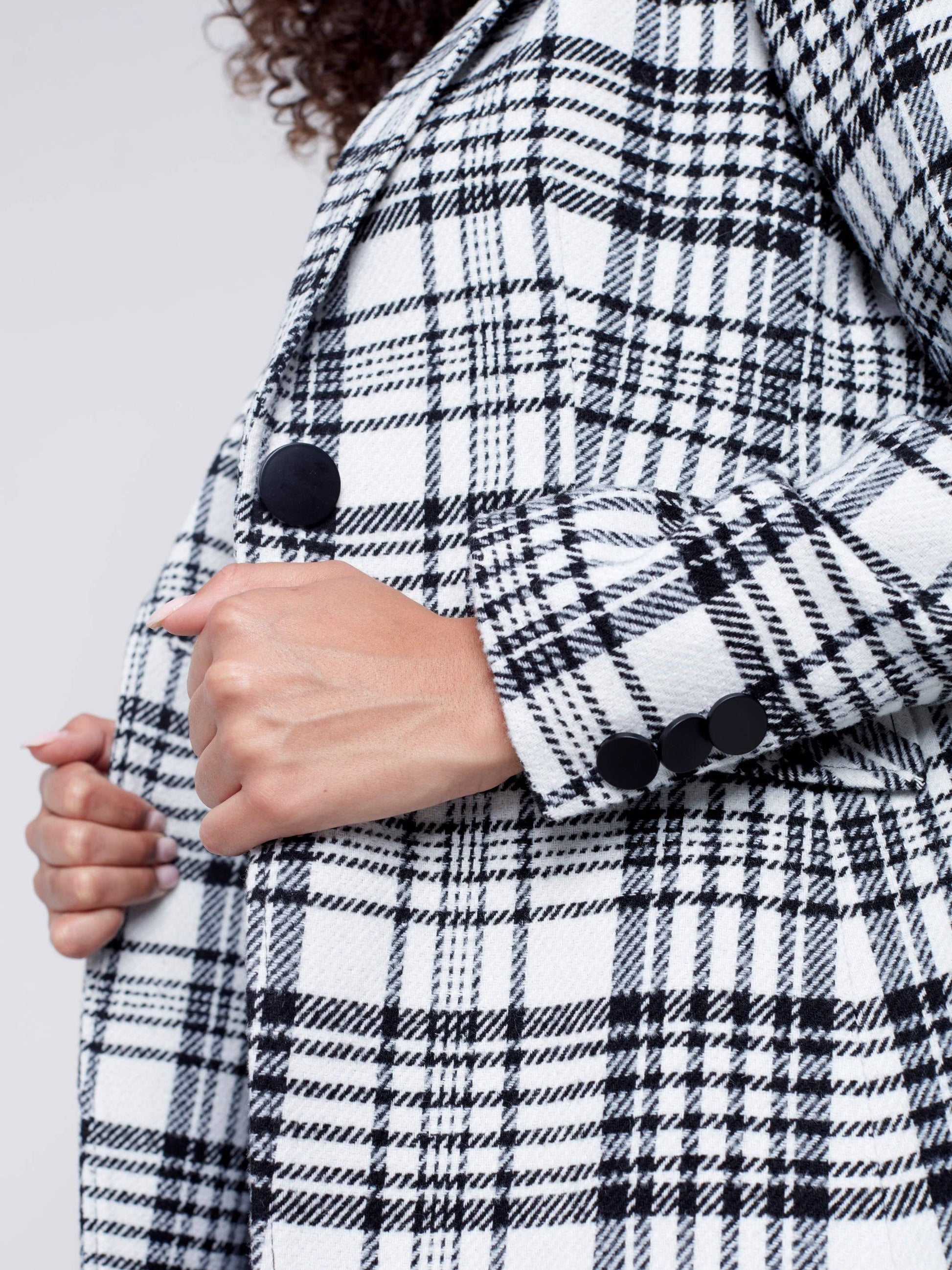 A woman wearing a Charlie B Plaid Long Blazer, perfect for formal occasions.