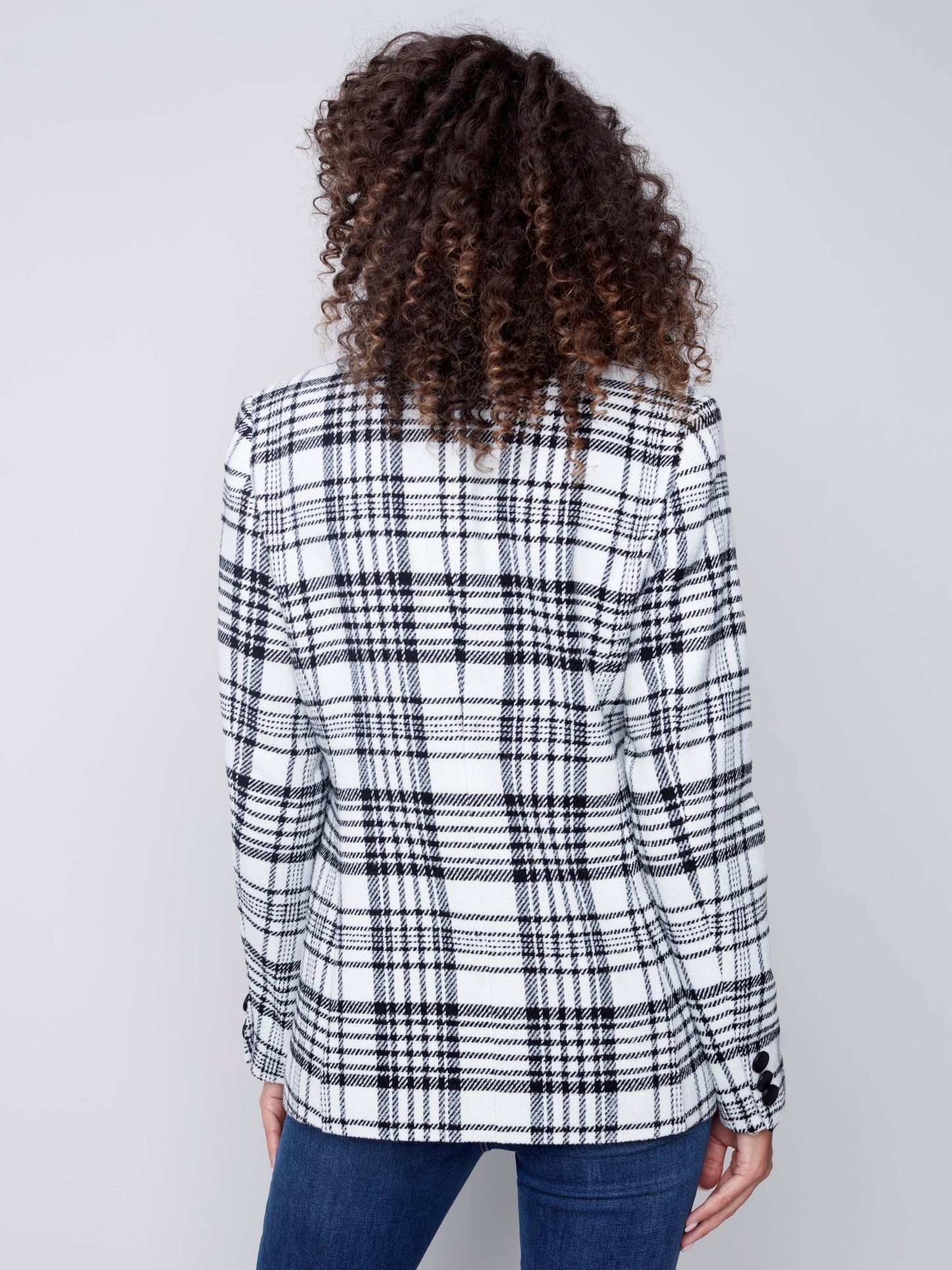 A woman wearing a Charlie B Plaid Long Blazer, perfect for formal occasions.