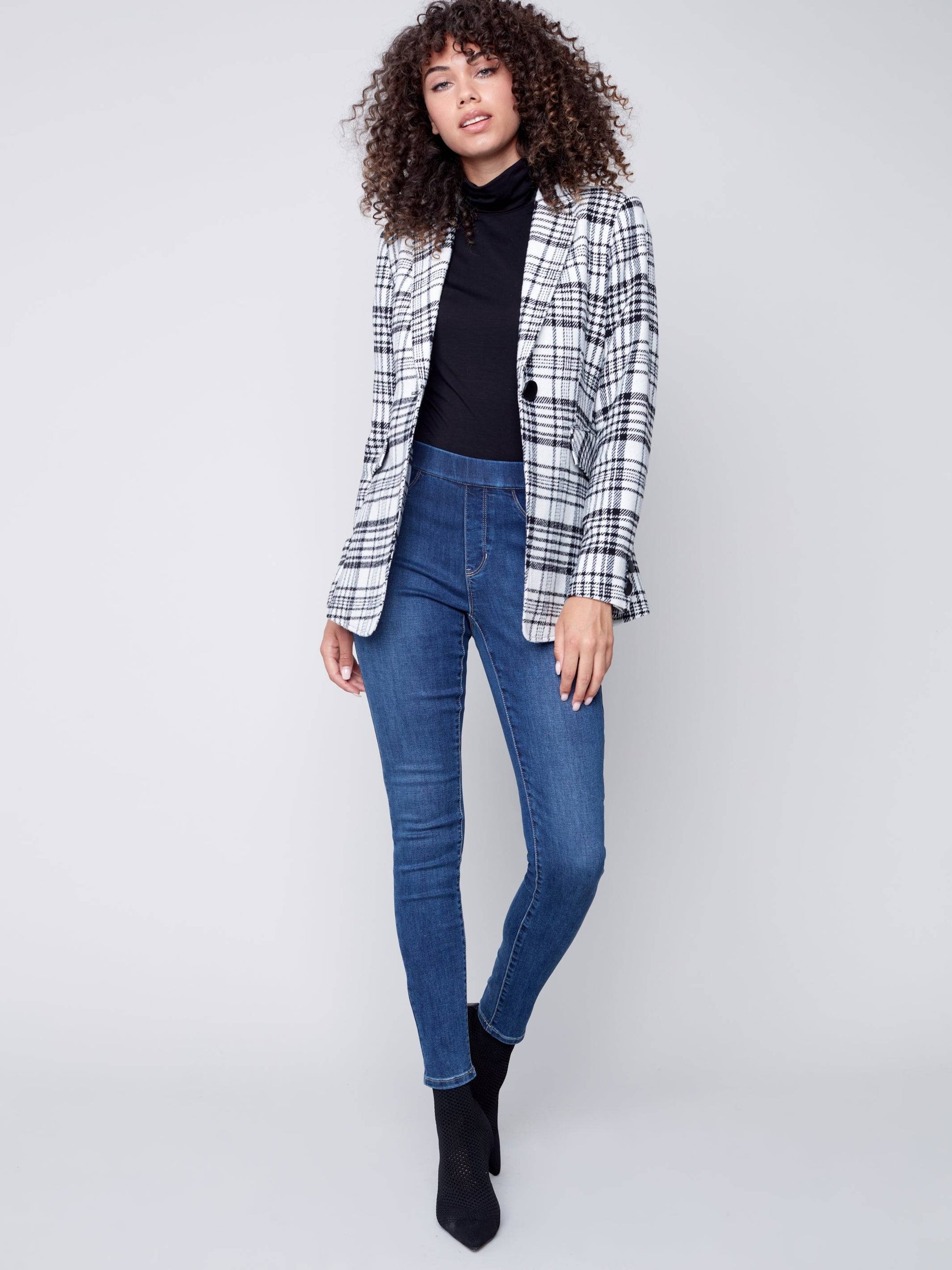 A woman wearing a Charlie B Plaid Long Blazer, perfect for formal occasions.