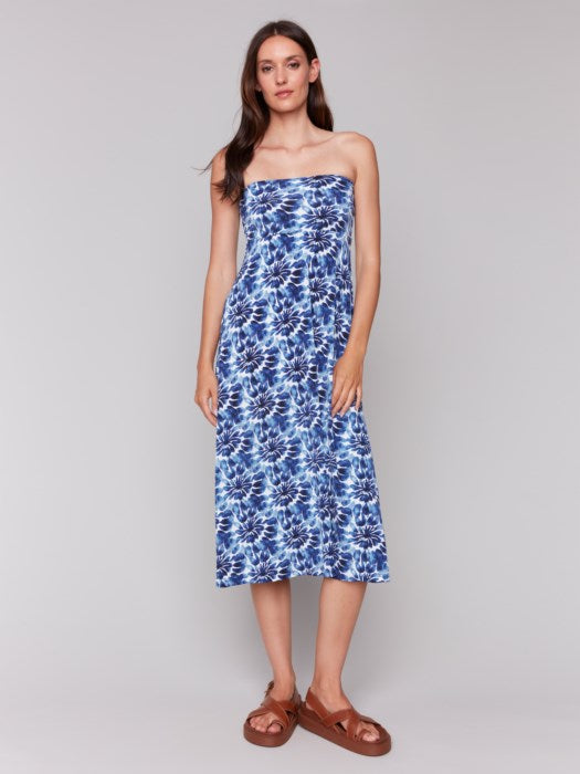 A model in a Charlie B Printed Convertible Skirt/Dress with removable spaghetti straps, featuring a blue and white tie-dye design, stands against a plain background.