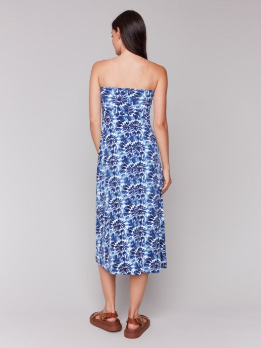 A model in a Charlie B Printed Convertible Skirt/Dress with removable spaghetti straps, featuring a blue and white tie-dye design, stands against a plain background.