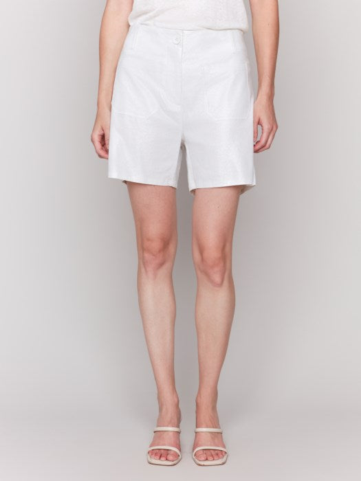 A person showcases their summer wardrobe from mid-thigh down, featuring Charlie B's Foil Linen Shorts with Patch Pockets and sandals, against a plain background.