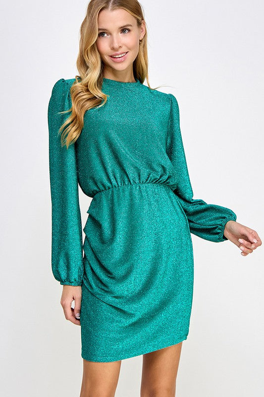 An elegant woman wearing a Vanilla Monkey Sparkly Holiday Dress for a special occasion, with long sleeves.