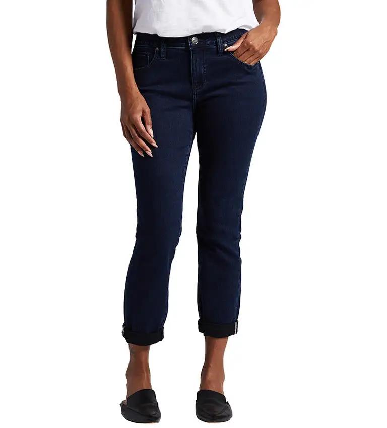 A woman is standing in Jag's Carter Girlfriend Jeans, which are sustainable denim jeans.