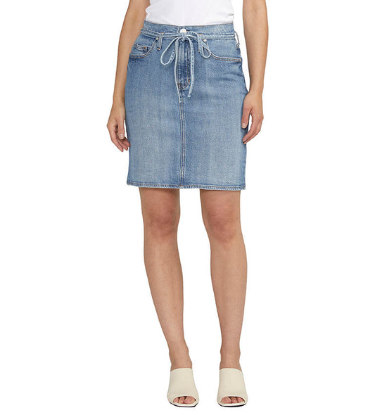 Woman wearing a Luna Knee Length Denim Skirt from Jag and white mules.