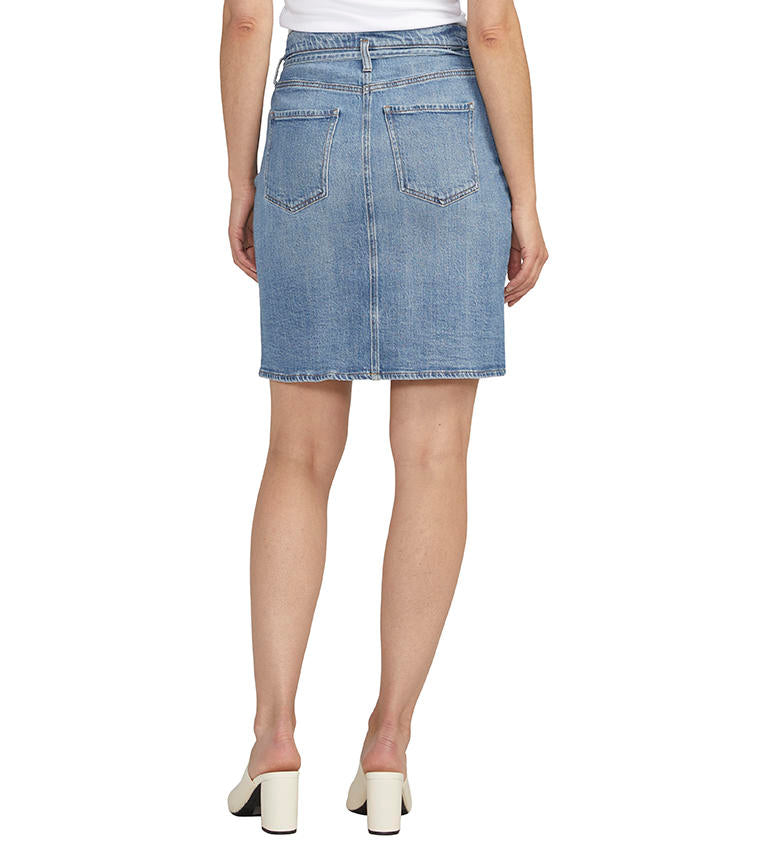 Woman wearing a Luna Knee Length Denim Skirt from Jag and white mules.