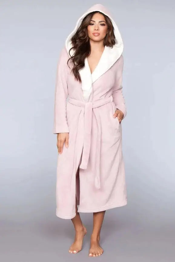 A woman wearing a BeWicked Janette Pink Robe with sherpa lining.