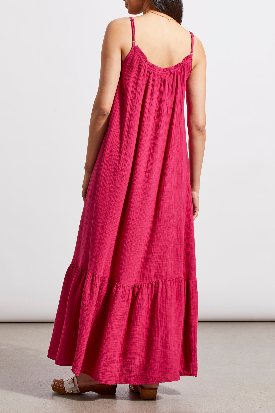 Woman in a Tribal fuchsia sleeveless maxi dress with a flowy design and ruffled hem, standing against a neutral background.