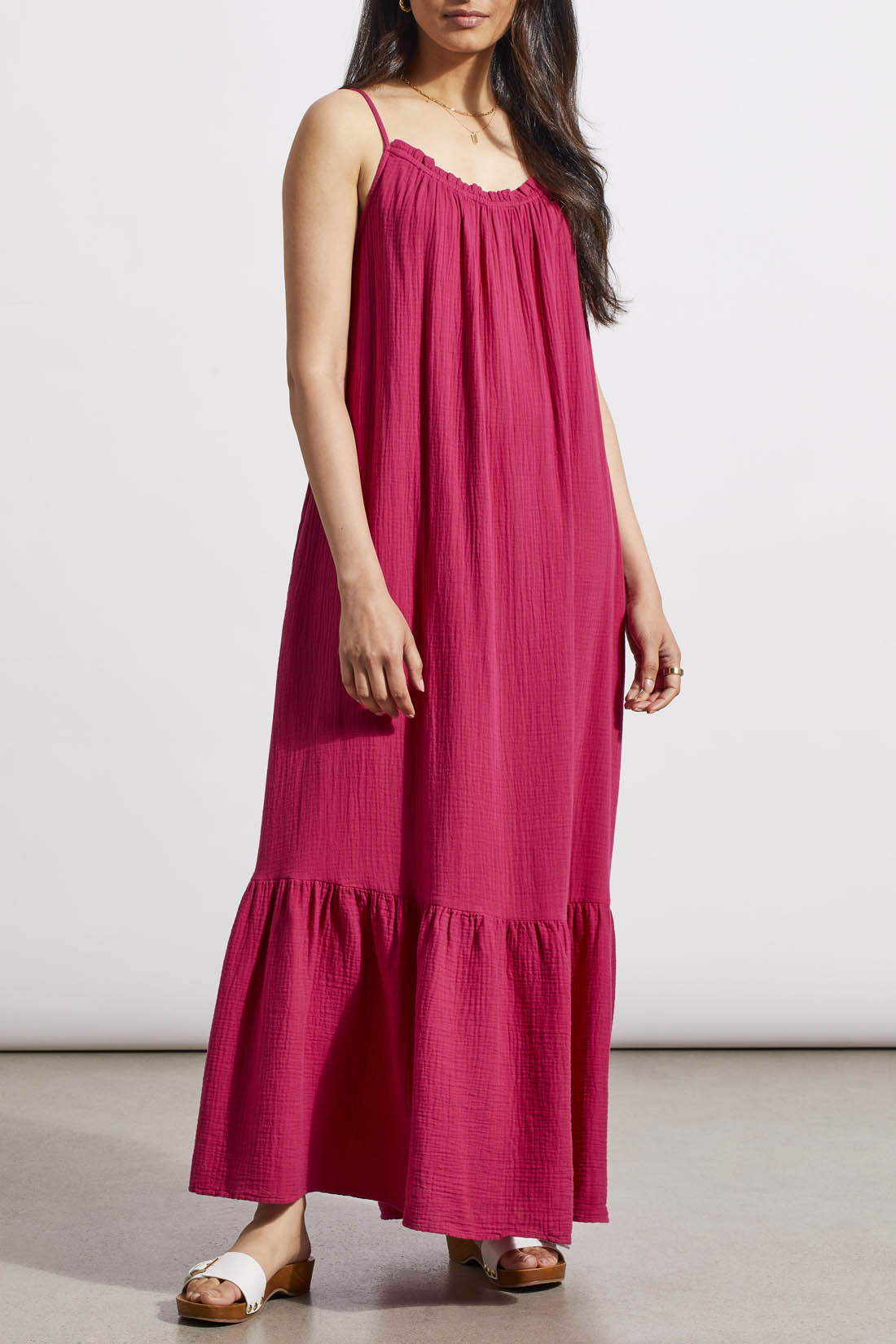 Woman in a Tribal fuchsia sleeveless maxi dress with a flowy design and ruffled hem, standing against a neutral background.