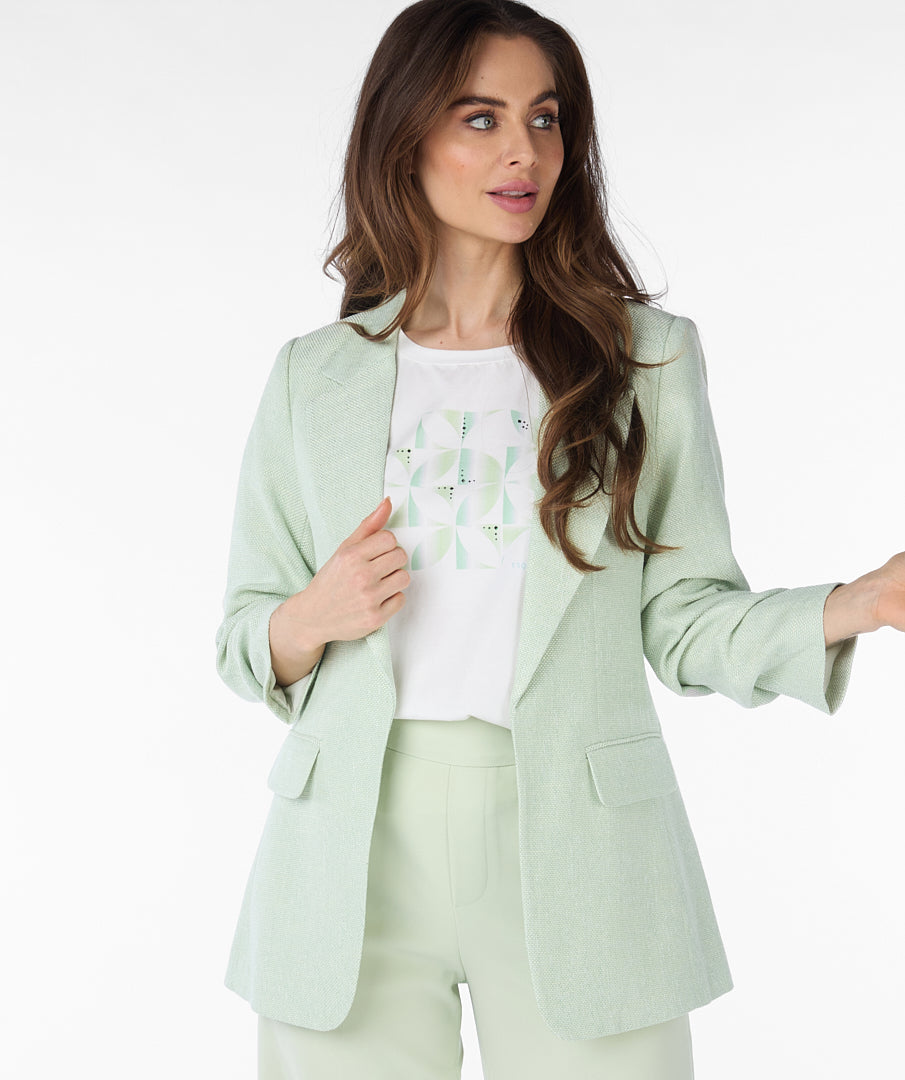 A person wearing the Esqualo Pastel Blazer and matching pants over a geometric patterned shirt showcases the versatility of this high-quality linen ensemble.