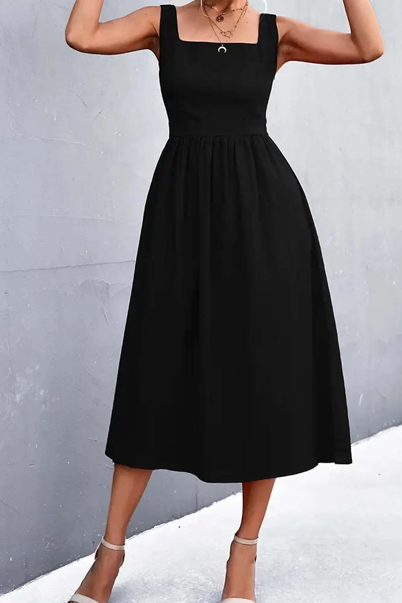 A woman wearing a Square Collar Sleeveless Solid A Line Midi Dress in Black color from Don't Be Chy Boutique.