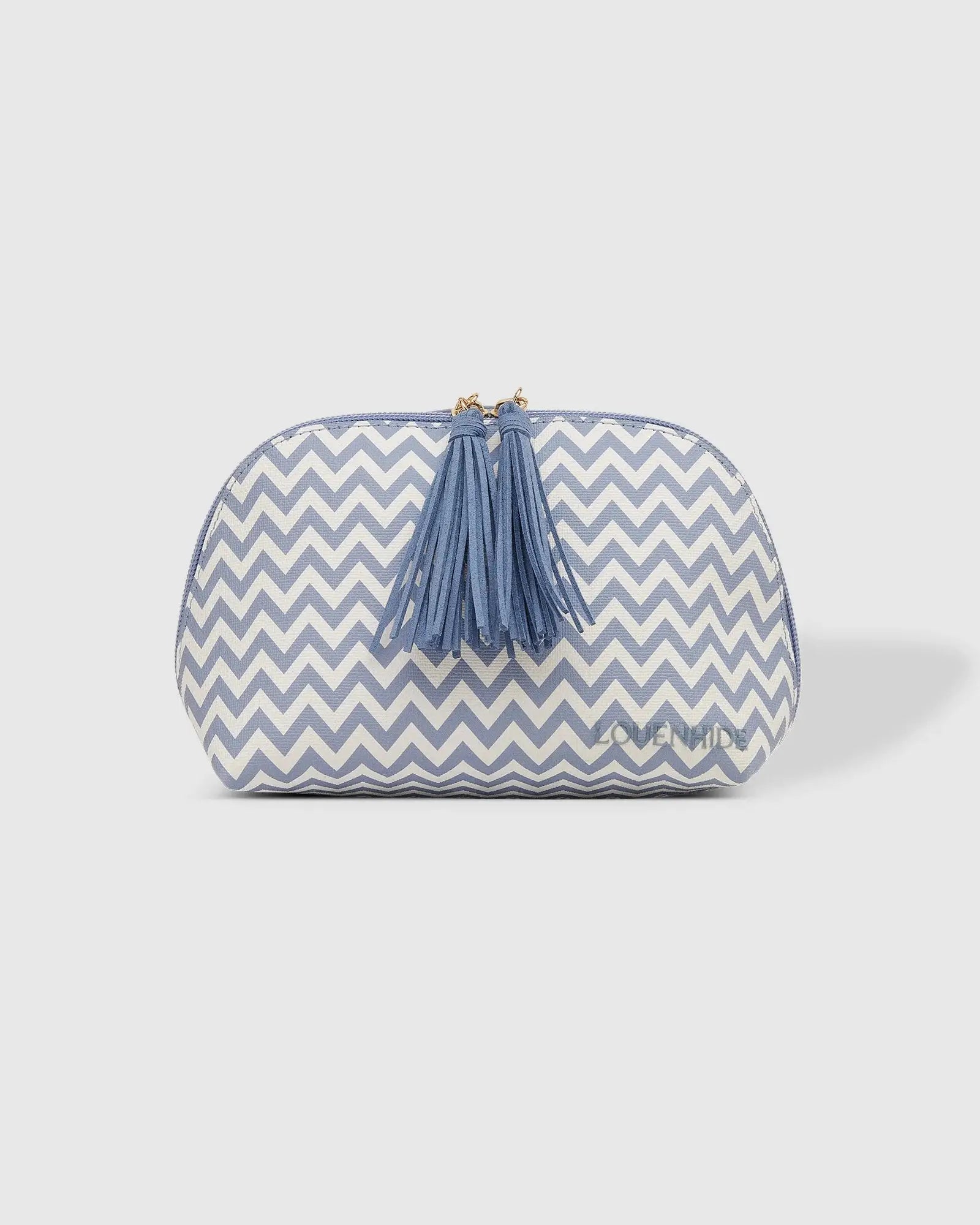 The Emma & Baby Audrey Cosmetic Set from Louenhide includes a blue rectangular travel cosmetic case with a black handle, paired with a smaller white and blue chevron-patterned pouch adorned with a pair of tassels. This set provides your largest toiletry case solution on the go.