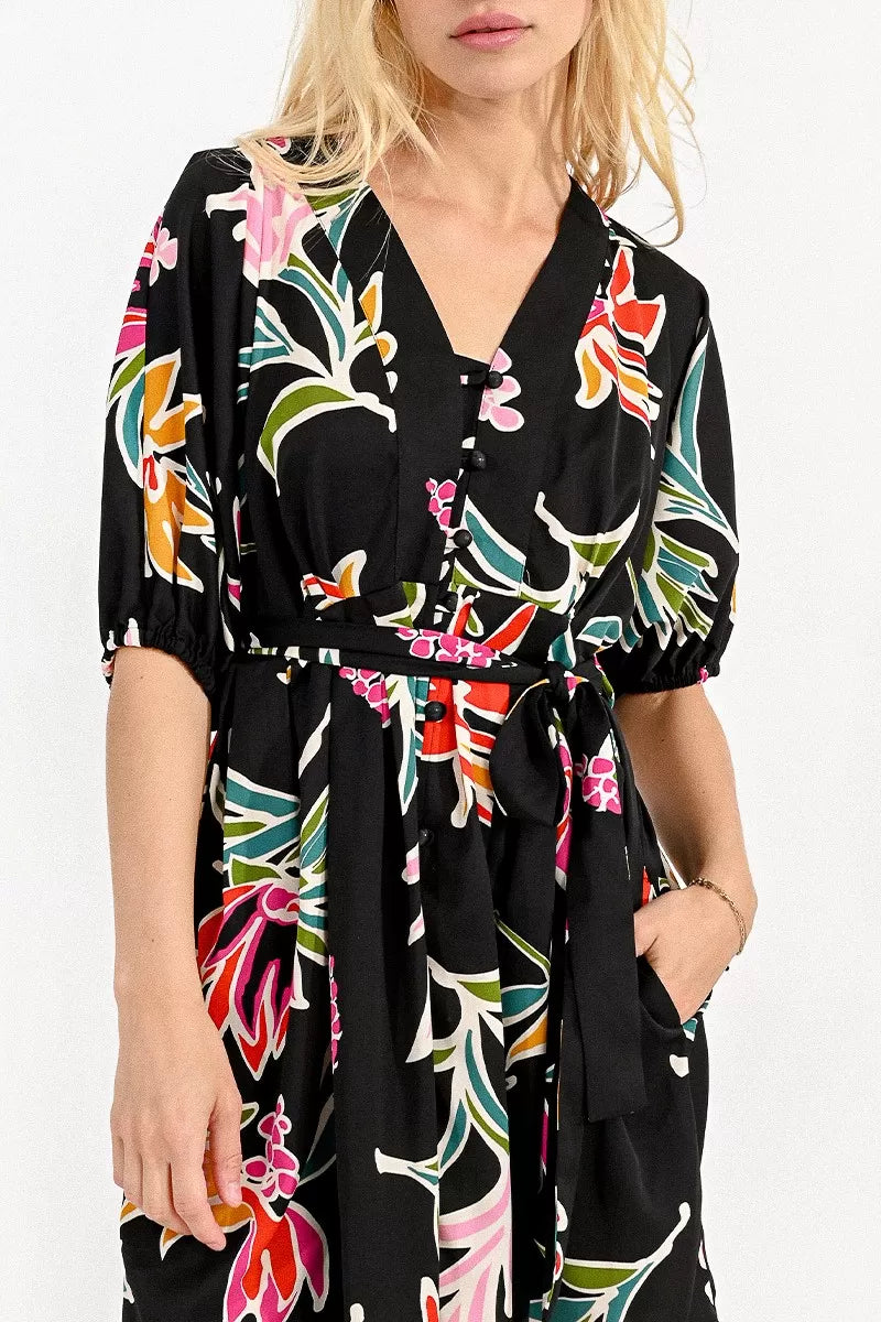 Woman wearing a Molly Bracken belted mini shirt dress with a floral print, ideal for a summer wardrobe.