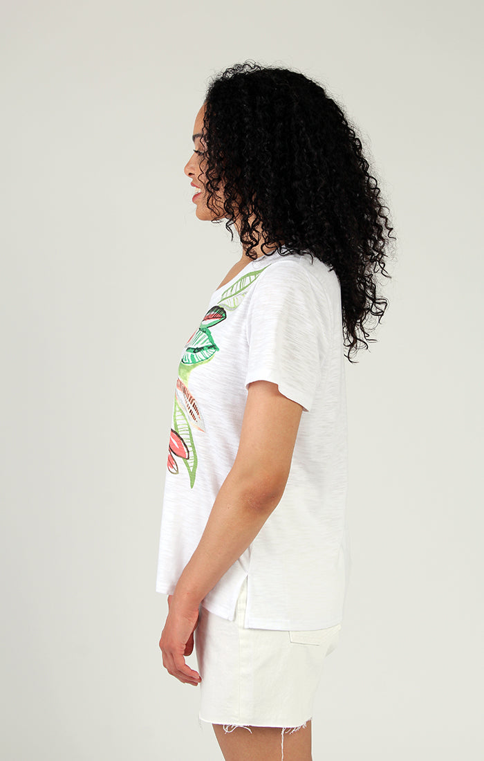 Woman wearing a stylish Fresh FX short sleeve leaf print cotton tee smiling at the camera.