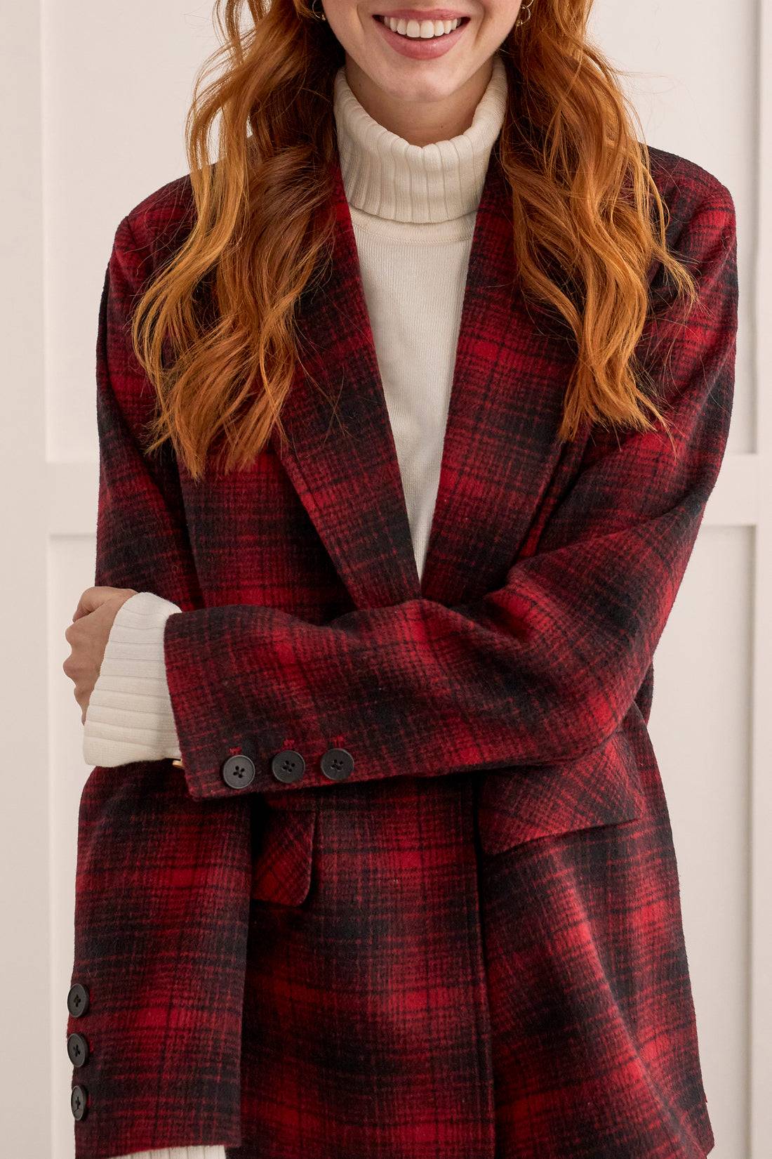 A stylish woman wearing a Tribal Red/Black Plaid Jacket.