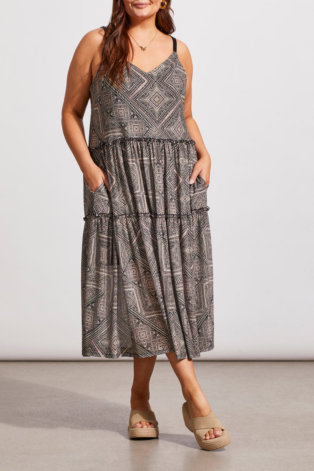 A woman in a Tribal Two Way Strappy Dress and white heels, posing in a studio setting.