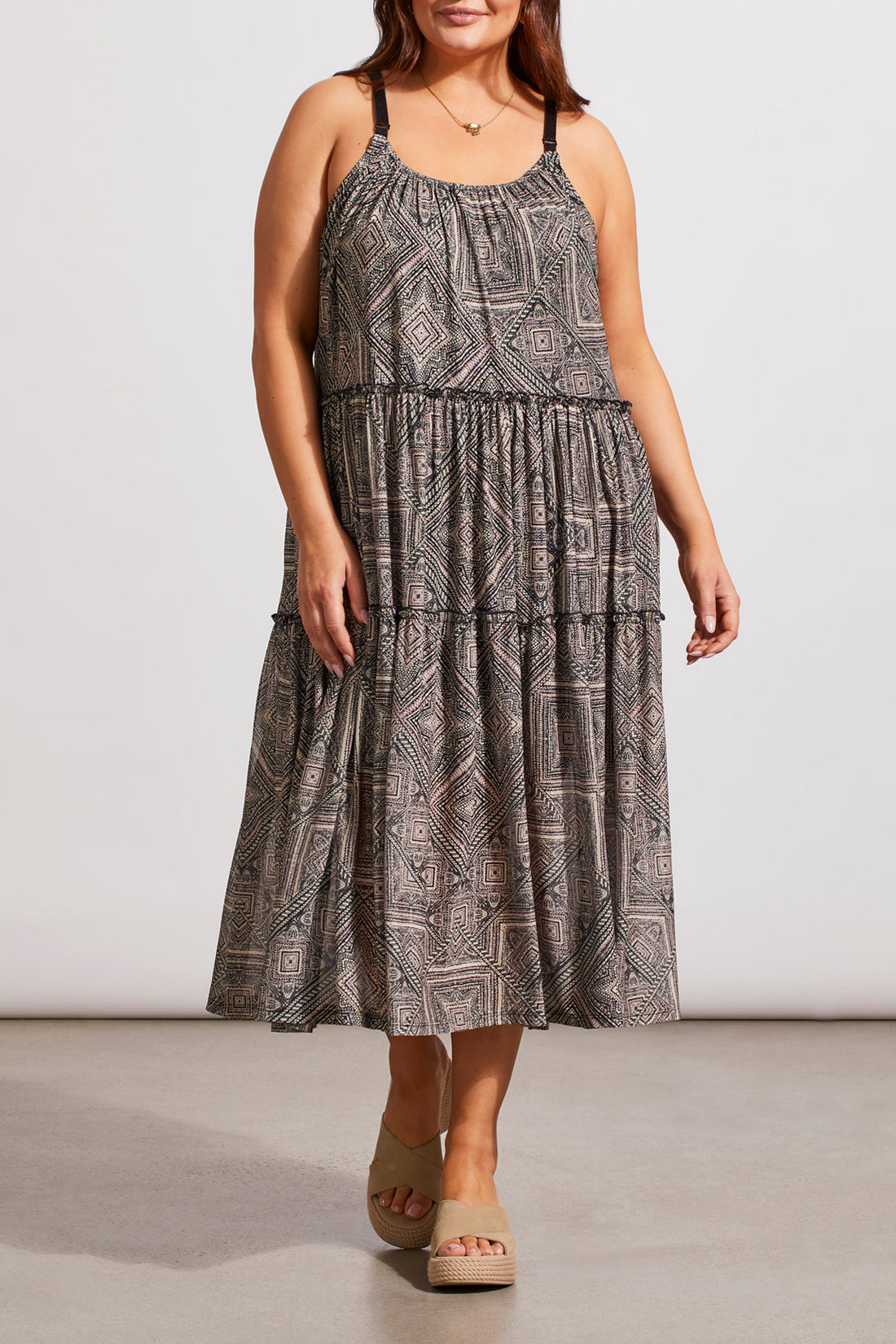 A woman in a Tribal Two Way Strappy Dress and white heels, posing in a studio setting.