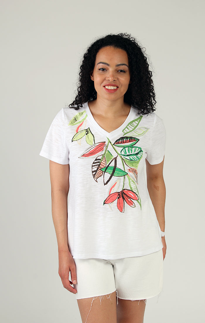 Woman wearing a stylish Fresh FX short sleeve leaf print cotton tee smiling at the camera.